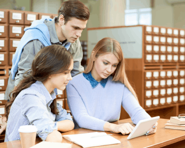 Students check a certified diploma translation with a notary seal, using Translation Service in Cicero for academic purposes.