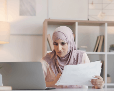 A translator adds Arabic labels to an engineering schematic on a laptop, using Arabic Translation Services in Illinois.