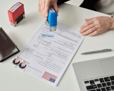 A notary seals a certified USCIS translation in a Chicago office while a client reviews it, using Translation Services.