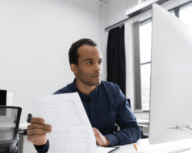 A business manager compares a certified translated contract with the original, using Translation Services in Evanston.