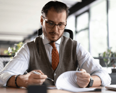 A Skokie manager signs a stamped certificate beside translated contracts, showing Translation Services in Skokie.