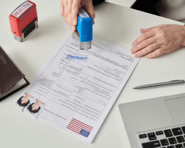 A certified translator stamps immigration forms for an individual, providing Chinese Translation Services in Illinois.