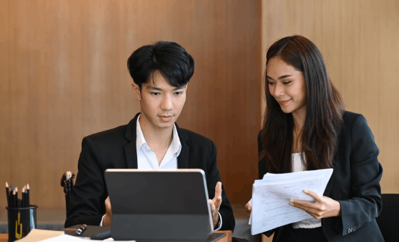 Certified translators review a legal contract for Chinese Translation in Illinois, ensuring the business terms accurate.