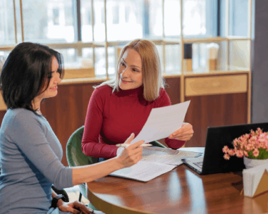 A client hands over a birth certificate for Translation Services in Skokie, getting a personal documents translation.