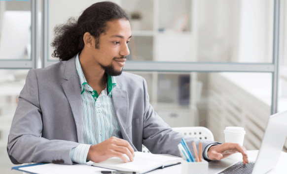 A native linguist checks a translated contract on a laptop, showing Translation Services in Evanston with native linguists.
