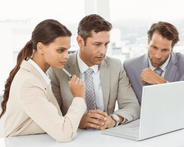 A Chicago business team reviews translated marketing copy on a laptop, using Translation Services in Chicago for global.
