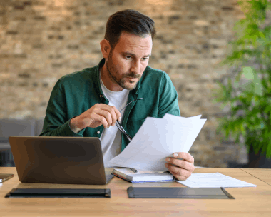 A linguist checks a Spanish birth certificate translation for USCIS forms, using Spanish Translation Services in Illinois.