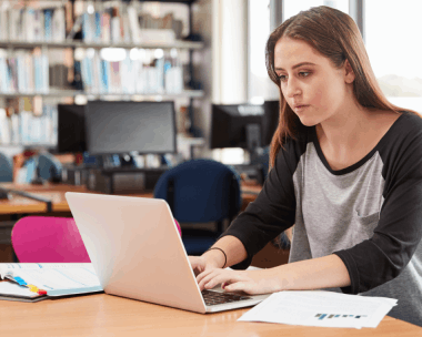 An Illinois student checks a translated diploma on a laptop, using Spanish Translation Services in Illinois for academic.