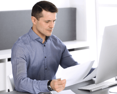 A translator compares a user manual to source diagrams, delivering Translation Services in Evanston for precise technical.