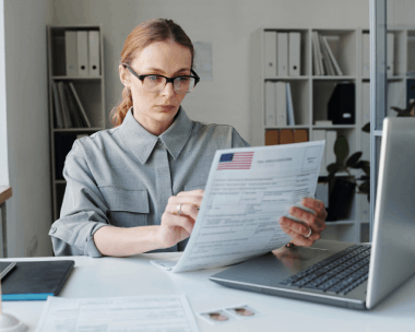 A native-language expert proofreads a contract for Translation Services in Chicago, ensuring accurate document translation.