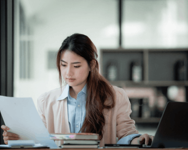 An expert translator compares source and target text on a laptop, providing Translation Services in Cicero for key documents.