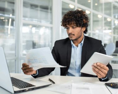 A translator reviews a client’s contract on a laptop, delivering document translation with Translation Services in Evanston.
